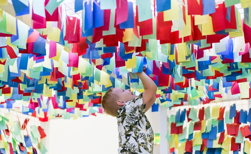 Boy playing with colourful exhibit at We The Curious